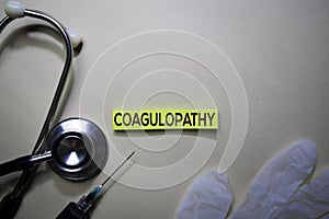 Coagulopathy text on Sticky Notes. Top view isolated on office desk. Healthcare/Medical concept