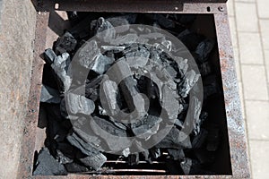 Coal on a barbeque ready to be lit..