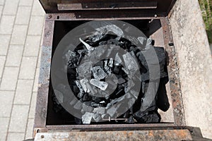 Coal on a barbeque ready to be lit..