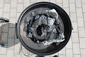 Coal on a barbeque ready to be lit..