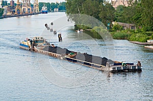 Coal barge sailing on the river