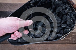 Coal being shoveled out of a coal scuttle