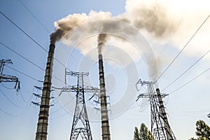 Coal burning industrial power plant with smoke stacks. Dirty smoke on the sky, ecology problems.