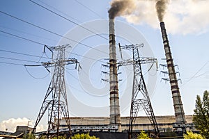 Coal burning industrial power plant with smoke stacks. Dirty smoke on the sky, ecology problems.