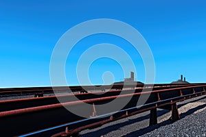 coal conveyor belt against a clear blue sky