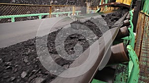 Coal on conveyor belt in rainy weather
