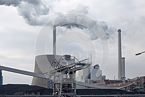 Coal-fired power plant with chimneys and white smoke