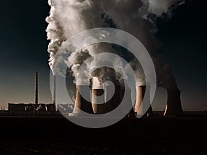 A coal-fired power station in the distance in agricultural landscape. Pocerady, Czech republic