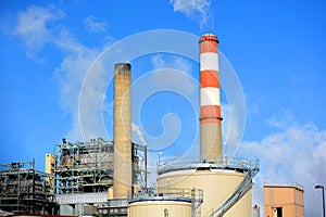 Coal Fossil Fuel Power Plant Smokestack with Red and White Colored Stripes Emits Carbon Dioxide Pollution photo