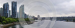 Coal Harbor in Vancouver British Columbia with downtown buildings boats and reflections in the water