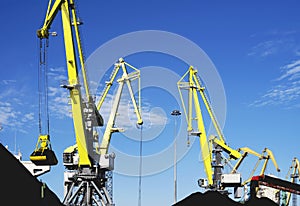 Coal is loaded into the holds of a dry cargo ship in the seaport 24 hours a day.