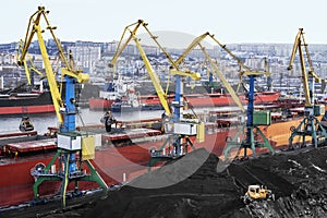 Coal is loaded into the holds of a dry cargo ship in the seaport 24 hours a day.