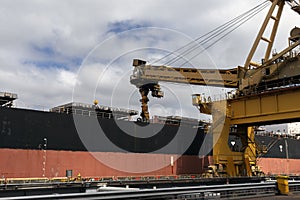 Coal loading equipment filling a ship with coal.