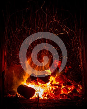 Coal and logs burning fire photo