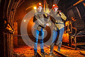 Coal Mine Excursion. Tired workers in a coal mine. Hard work in a coal mine.