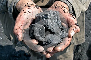 Coal miner in the hands of