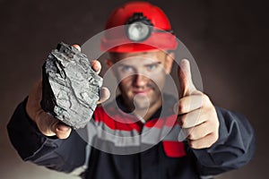 Coal miner with lump of coal