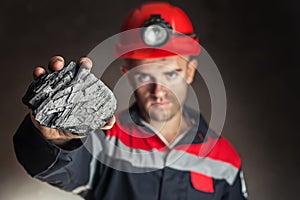 Coal miner showing lump of coal photo