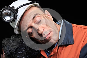 Coal miner showing lump of coal with thumbs up