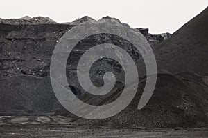 Coal mining at an open pit. Pile of black coal pieces