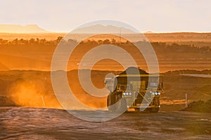 Coal mining truck in orange morning light