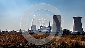 Coal power generating station with cooling towers in dry landscape