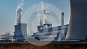 Coal power generating station with cooling towers in dry landscape