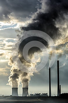 Coal power plant chimneys spew smoke and pollution