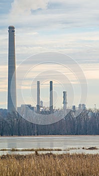 Coal power plant with gases and pollutants coming out of smoke stacks - off the Minnesota River and major bird migration route