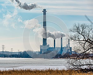 Coal power plant with gases and pollutants coming out of smoke stacks - off the Minnesota River and major bird migration route