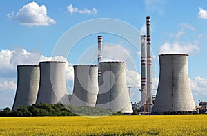 Coal power plant over yellow agriculture field