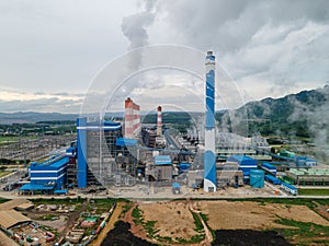 Coal power plant with steam pouring out of the stack.