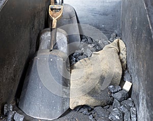 coal and shovels in metal container