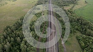 Coal train aerial view. An electric locomotive with freight cars or a railway carriage travels by rail.A train with coal is travel