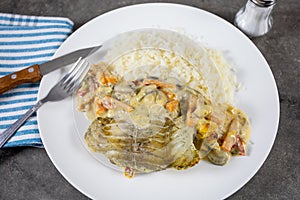 Coalfish fillet cooked in sauce