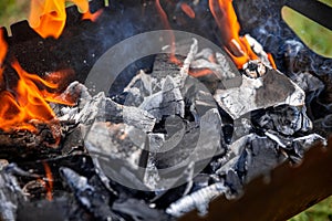 Coals burn in the grill