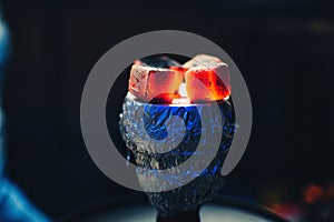 Coals of Shisha on foil on bowl with tobacco Smoking and red hot