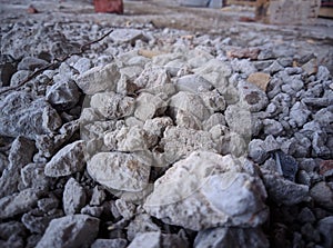 Coarse aggregates covered with cement and dust