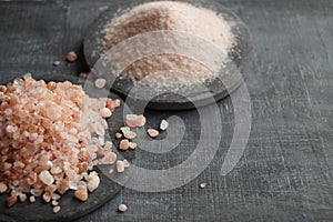 Coarse and fine Himalayan salt on a black background