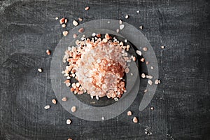 Coarse and fine Himalayan salt on a black background