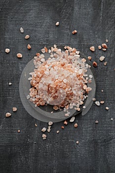 Coarse and fine Himalayan salt on a black background