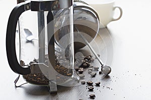 Coarse ground coffee bean in clear French press mug