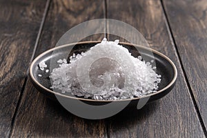 Coarse salt on dark plate closeup