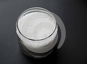 Coarse salt grains in a transparent glass jar