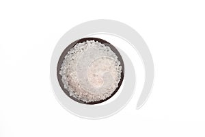 Coarse salt in small bowl on white background