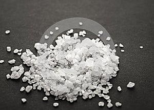 coarse sea salt on a black table close-up