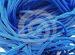 Coarse textured blue ropes with irregular and chaotic windings or turns photo