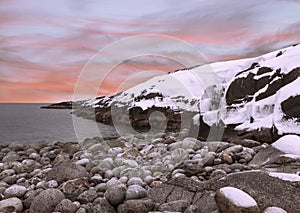 The coast of the Barents sea in winter sunset