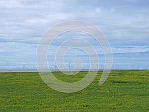 The coast at blundell sands in crosby near southport with the wind turbines at burbo bank visible in the distance