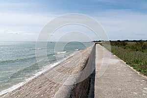 Coast and breakwater wave protection dike on Ile de RÃ© in France with the path